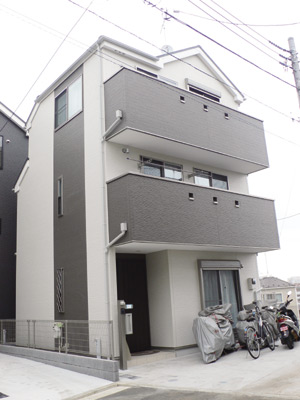 白とグレーの色使いがシャープな印象の鈴木さんのお宅。２階と３階にそれぞれ大きなバルコニーが設けられている